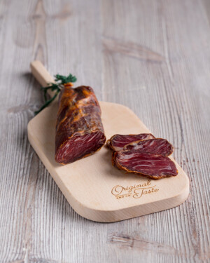 Lomito Ibérico de Bellota adobado a mano se muestra corte sobre tabla de madera